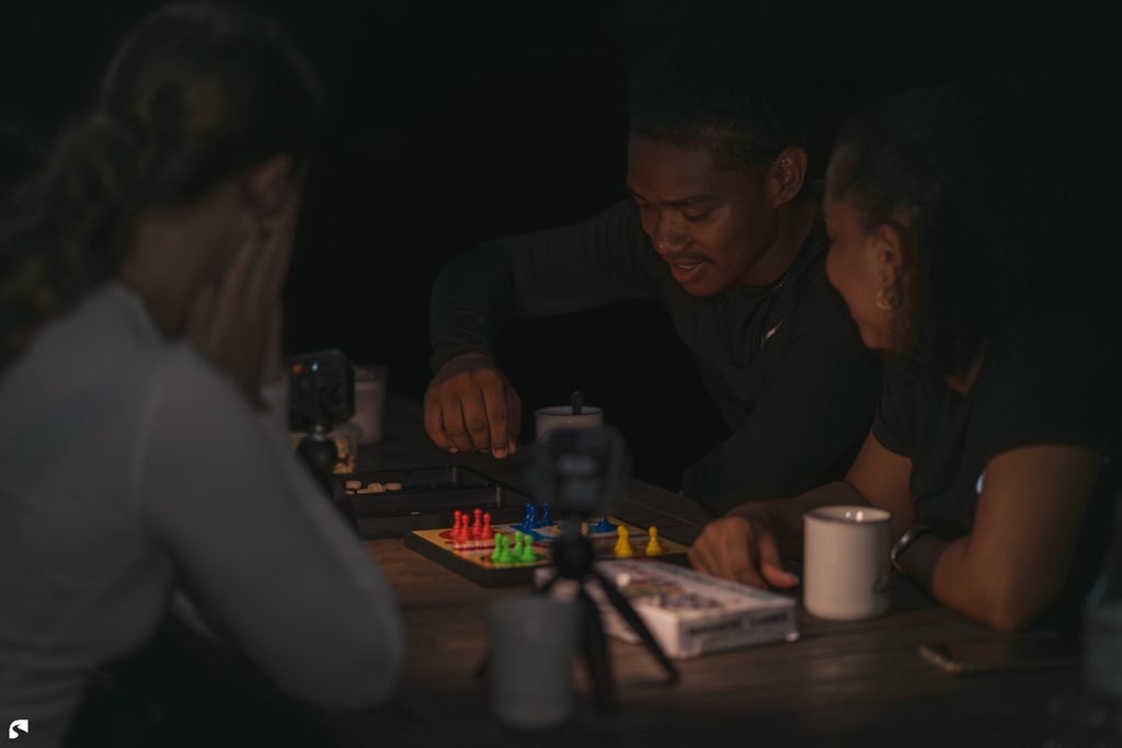 Friends playing a board game together at Stephanie’s Lodge in Nickerie, Suriname.