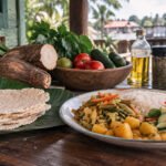 Gluten-free Surinamese meal with rice, vegetables, cassava bread, plantain and fresh produce by the river.
