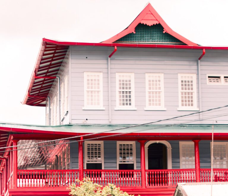 Historic wooden building in Paramaribo with Chinese architectural influences and red decorative trim